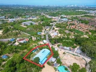Arial view of a large property with outlined boundary near urban area