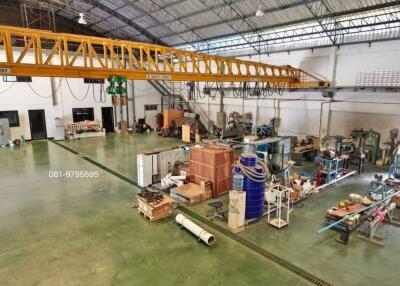 Spacious industrial workshop with crane and various equipment