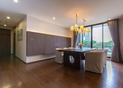 Elegant dining room with hardwood floors and modern lighting