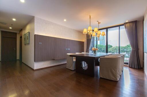 Elegant dining room with hardwood floors and modern lighting