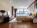 Spacious and modern bedroom with large windows and elegant furnishings