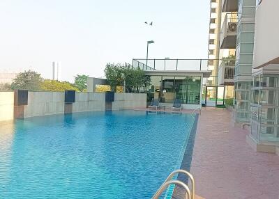 Outdoor swimming pool next to a high-rise residential building