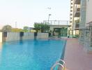 Outdoor swimming pool next to a high-rise residential building