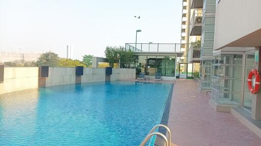 Outdoor swimming pool next to a high-rise residential building