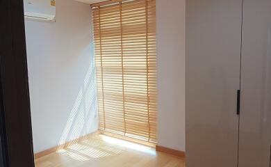 Bright bedroom with wooden blinds and natural light