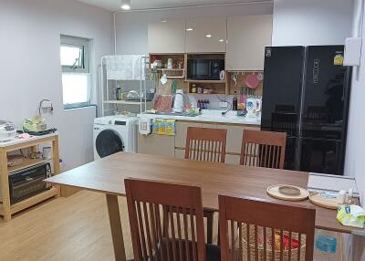 Spacious combined kitchen and dining area with modern appliances
