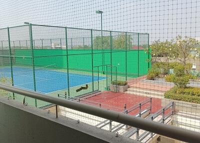 View from the balcony overlooking tennis courts and garden