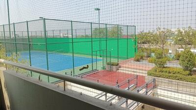 View from the balcony overlooking tennis courts and garden