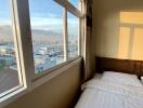 Bright bedroom with large window showing cityscape