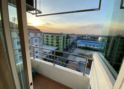 Spacious balcony with a wide view over the urban landscape at sunset
