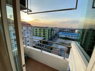 Spacious balcony with a wide view over the urban landscape at sunset