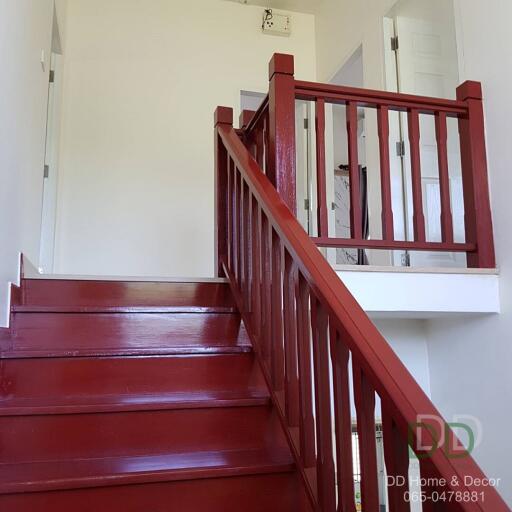 Bright red staircase in a residential home leading to upper floor