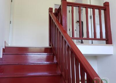 Bright red staircase in a residential home leading to upper floor
