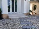 Exterior view of a modern house with stone pathway