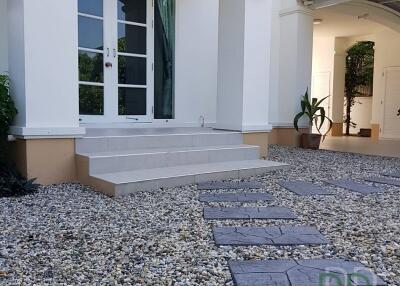 Exterior view of a modern house with stone pathway