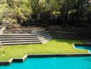 Lush garden with pool and seating steps