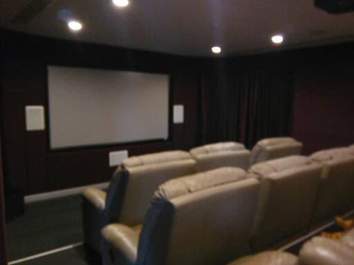 Luxurious home theater with large screen and comfortable seating