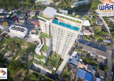 Aerial view of a modern residential building complex surrounded by green space