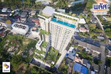 Aerial view of a modern residential building complex surrounded by green space