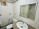 Modern bathroom with granite countertop and white ceramic fixtures