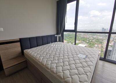 Modern bedroom with expansive city view through large windows