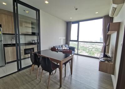 Spacious living room with dining area and city view