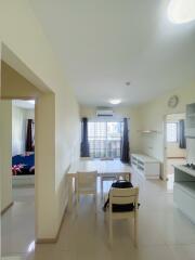 Bright and spacious living room with adjacent bedroom view