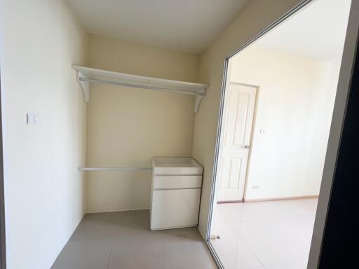 Empty bedroom with built-in closet and natural light