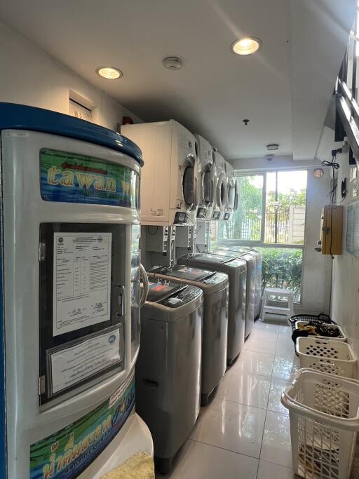 Well-equipped laundry room in apartment with multiple washers and dryers