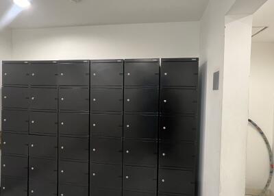 Interior view of a building showing rows of black metal lockers