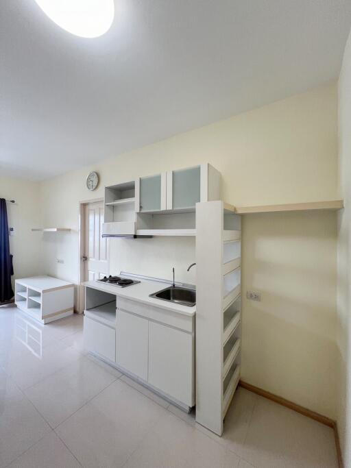 Modern and compact kitchen space with clean design and white cabinetry