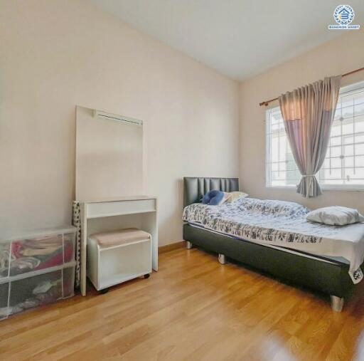 Bright and cozy bedroom with wooden flooring and natural light