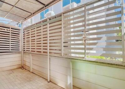 Bright and airy covered balcony with privacy screens