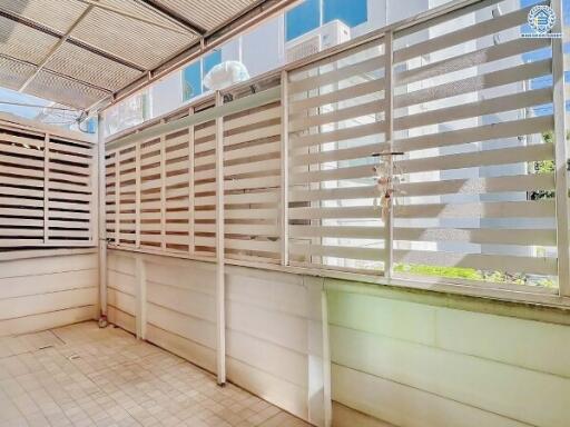 Bright and airy covered balcony with privacy screens