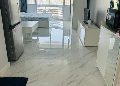 Modern kitchen with marble flooring and abundant natural light