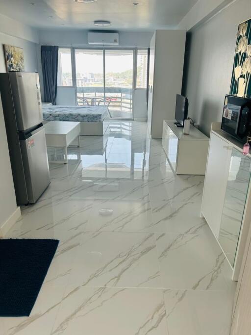 Modern kitchen with marble flooring and abundant natural light