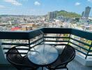 Spacious balcony overlooking the city with table and chairs