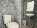 Modern bathroom with marble tiles and white fixtures