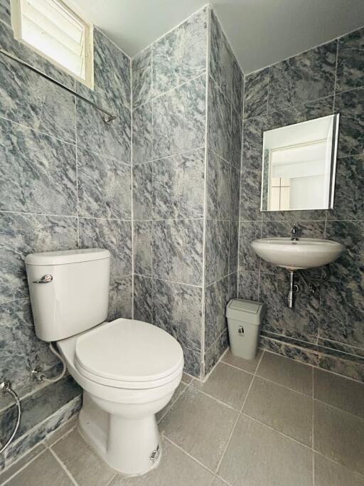 Modern bathroom with marble tiles and white fixtures