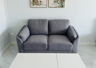 Modern living room with gray sofa and white coffee table