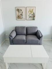 Modern living room with gray sofa and white coffee table