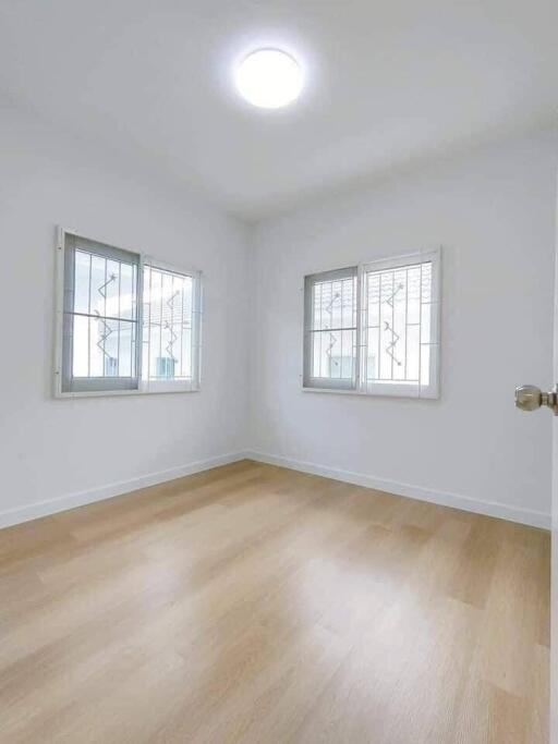 Bright and airy empty bedroom with large windows