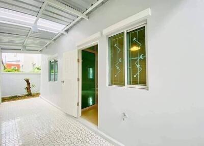 Bright and welcoming home entrance with tiled floor and decorative door