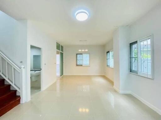 Spacious and well-lit living room with glossy tiled flooring