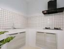Modern kitchen with white tiles and under-cabinet lighting