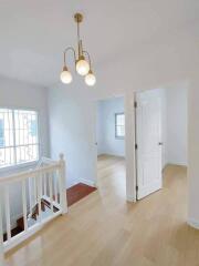 Bright and spacious hallway with hardwood floors and modern lighting