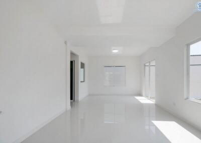 Spacious and bright empty room with large windows and glossy white floors