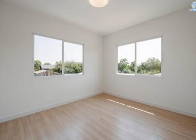Spacious and well-lit empty bedroom with large windows