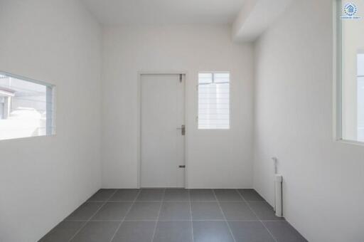 Minimalistic empty room with gray tiled floor and white walls