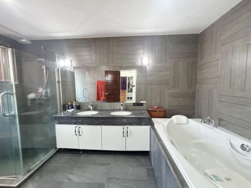 Spacious modern bathroom with dual sinks and large tub